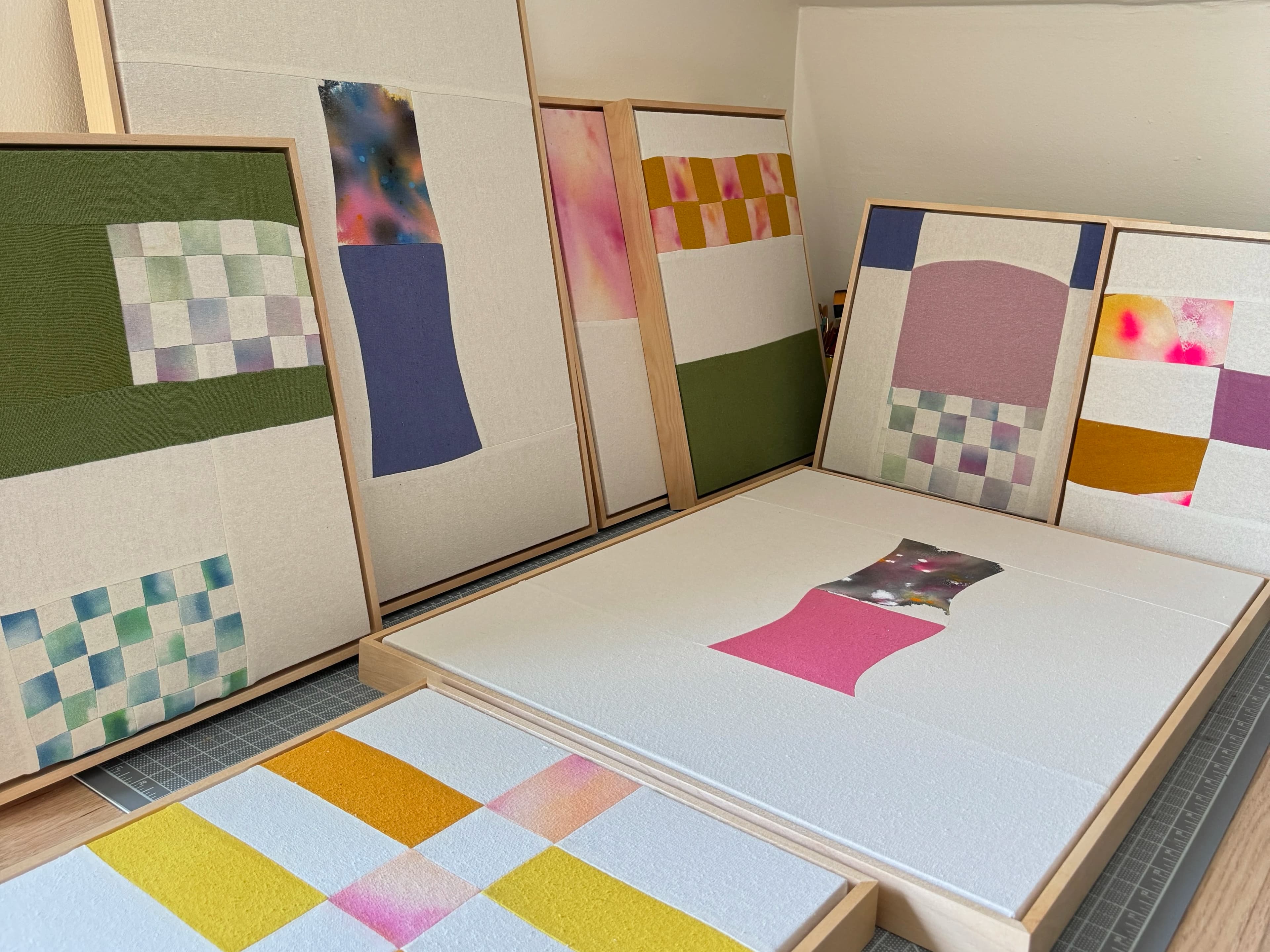 Multicolored patchwork textile pieces by artist Anastasia Greer in her studio.