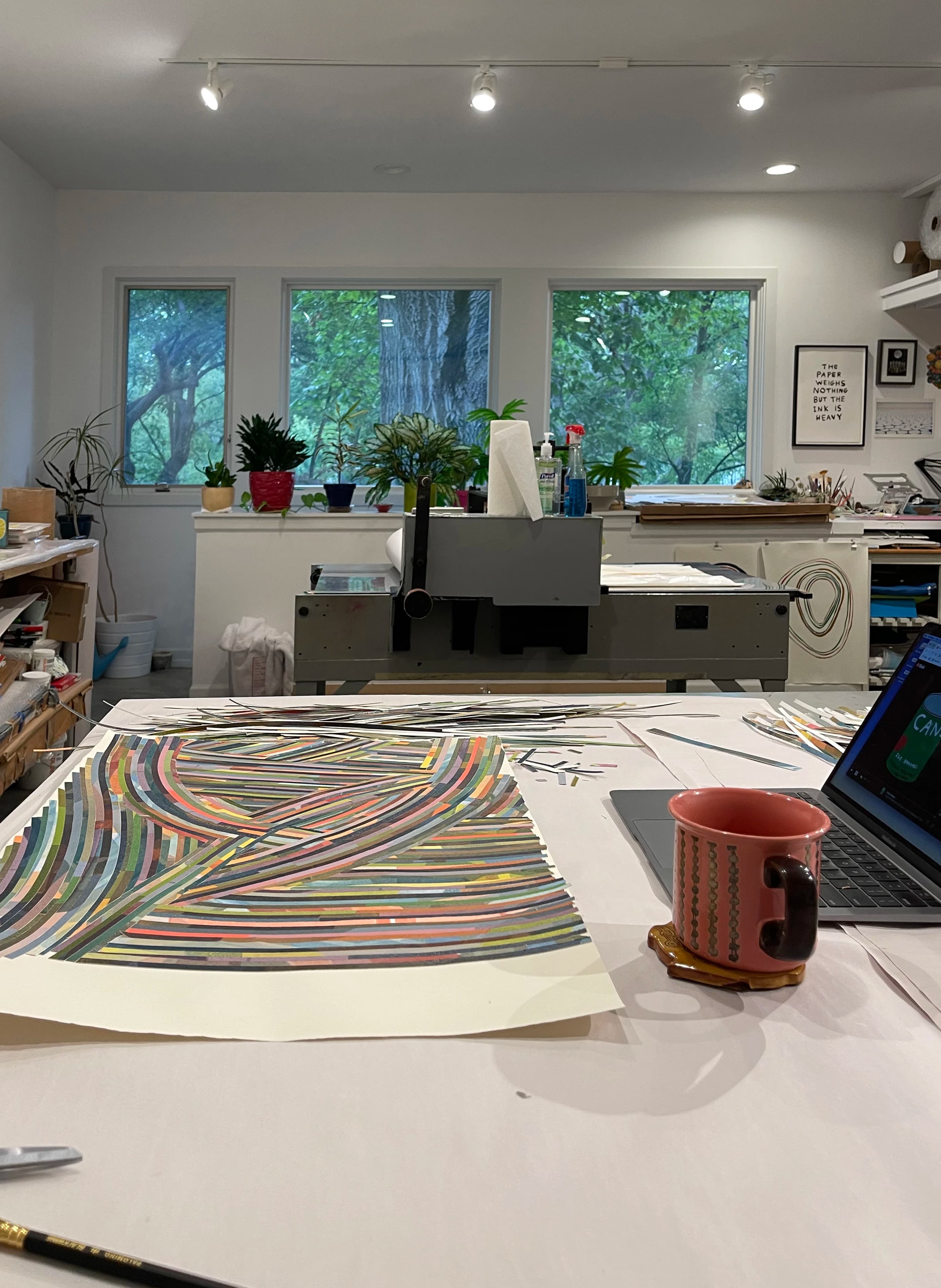 In-progress colorful collage made from strips of paper by artist Laura Berman.