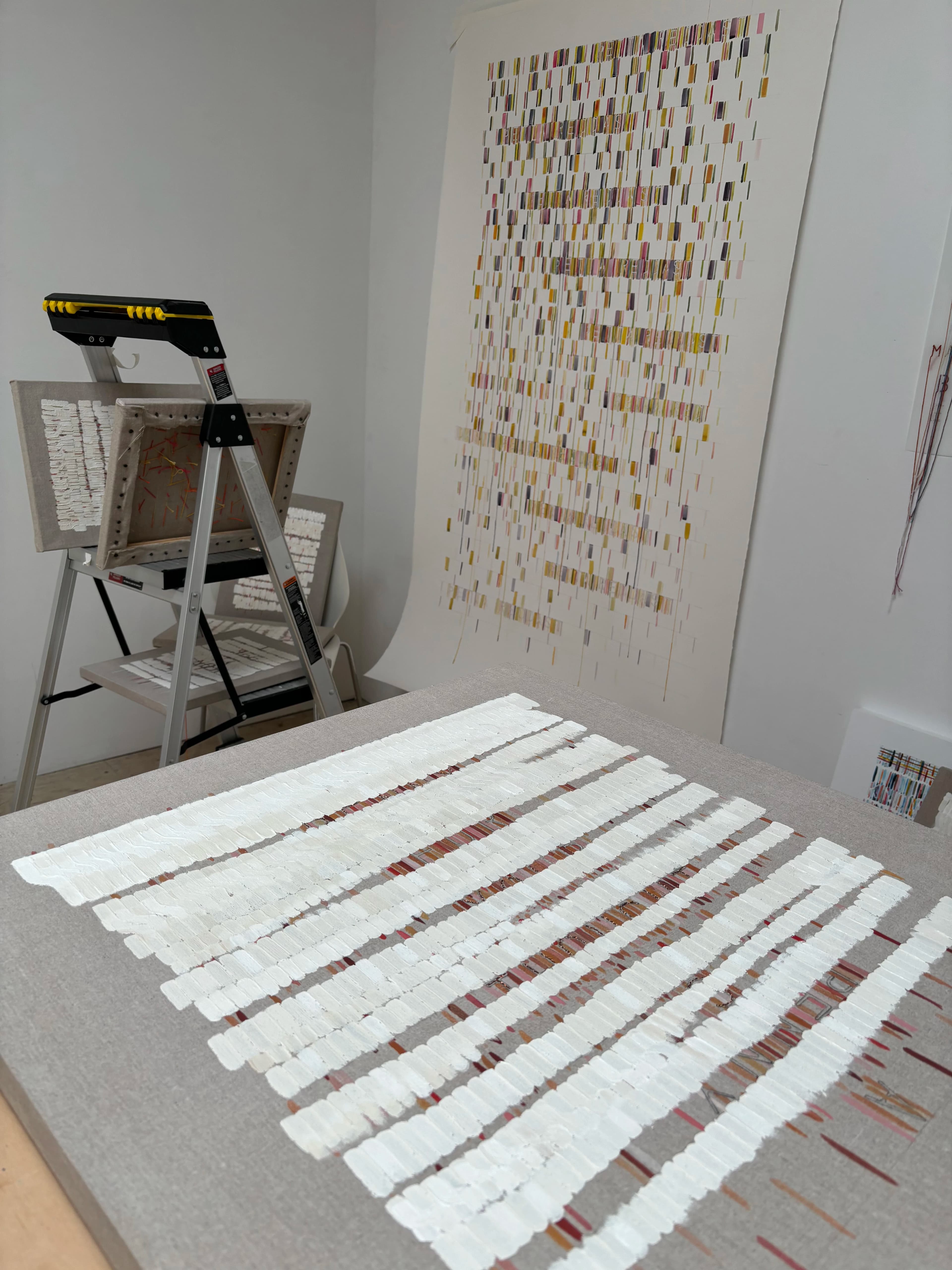 Abstract, text-based paintings and work on paper by artist Gail Tarantino in her studio.