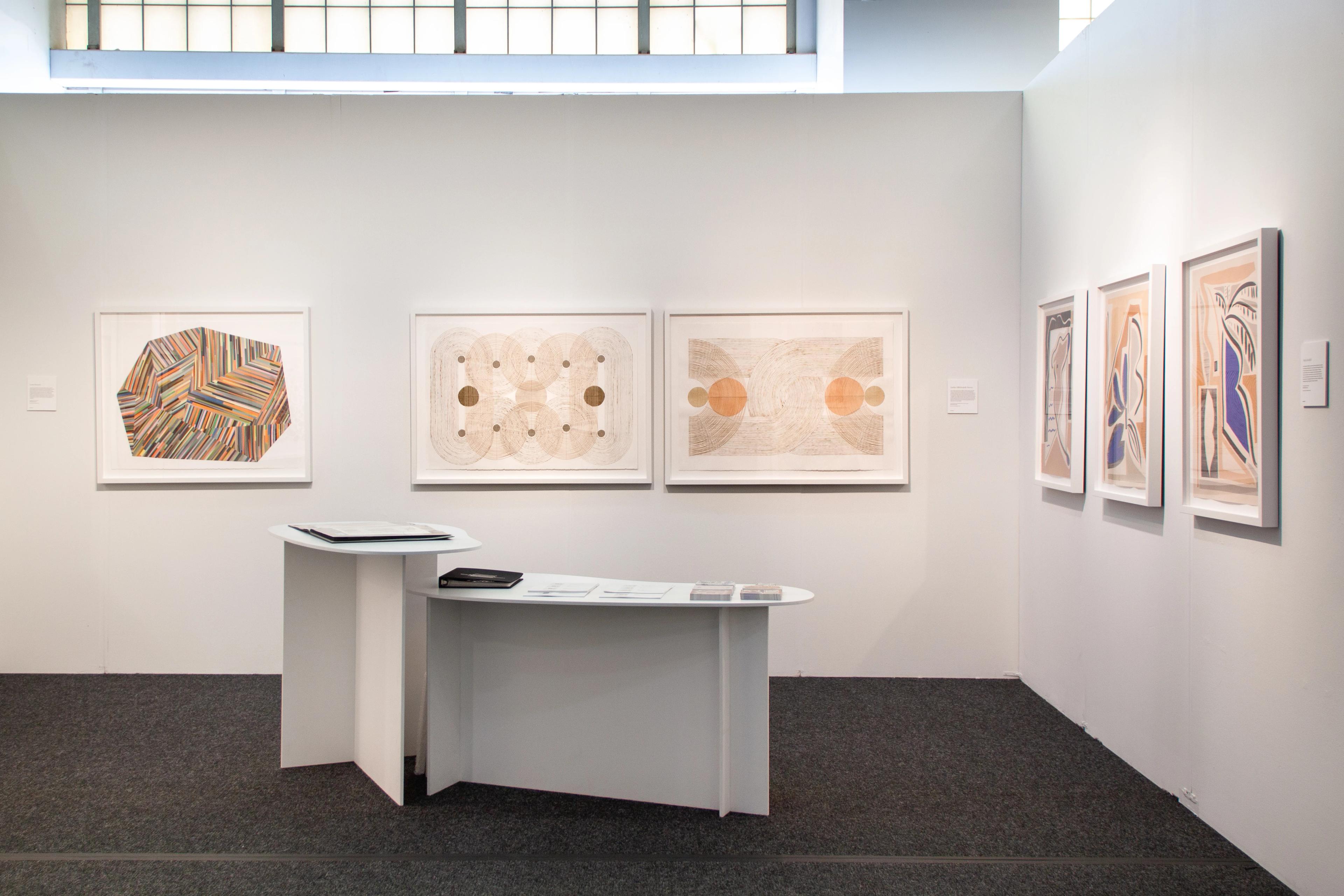 Artworks by Laura Berman, Katrine Hildebrandt-Hussey, and Anna Koeferl in a booth at Art on Paper in 2024.