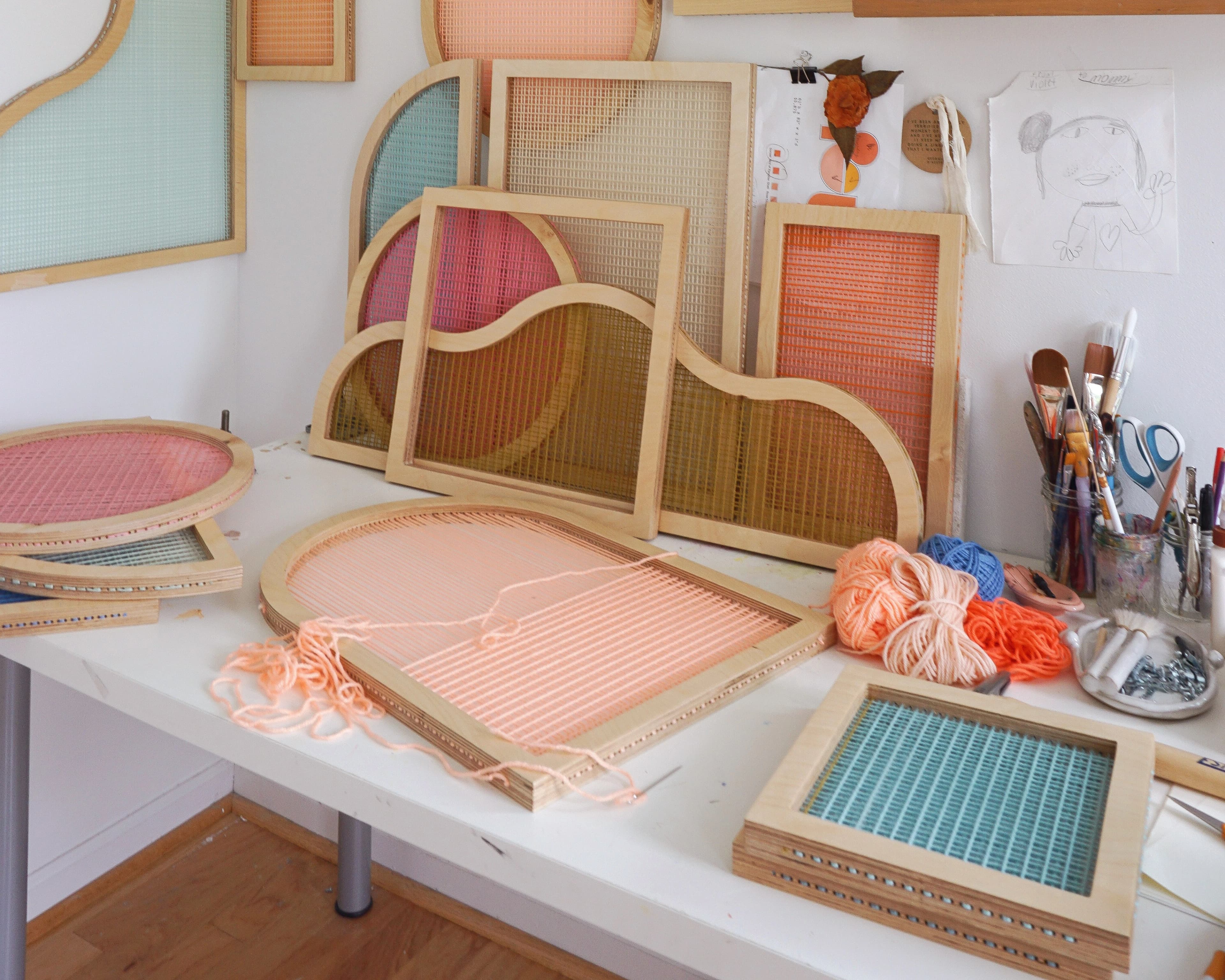 Colorful shaped screens made from acrylic yarn by artist Hayley Sheldon in her studio.