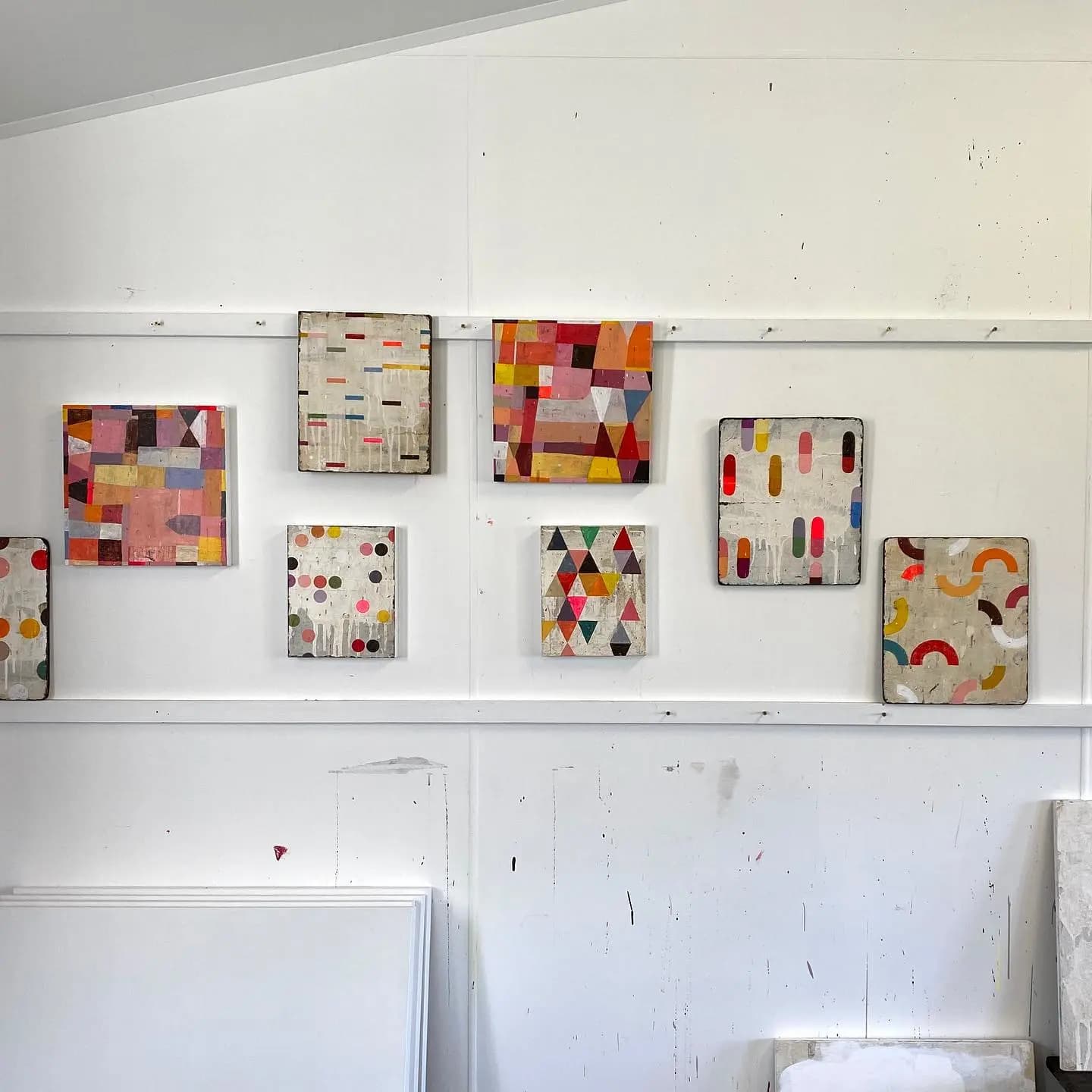 Abstract, geometric works of various sizes in artist Susan Simonini's studio.