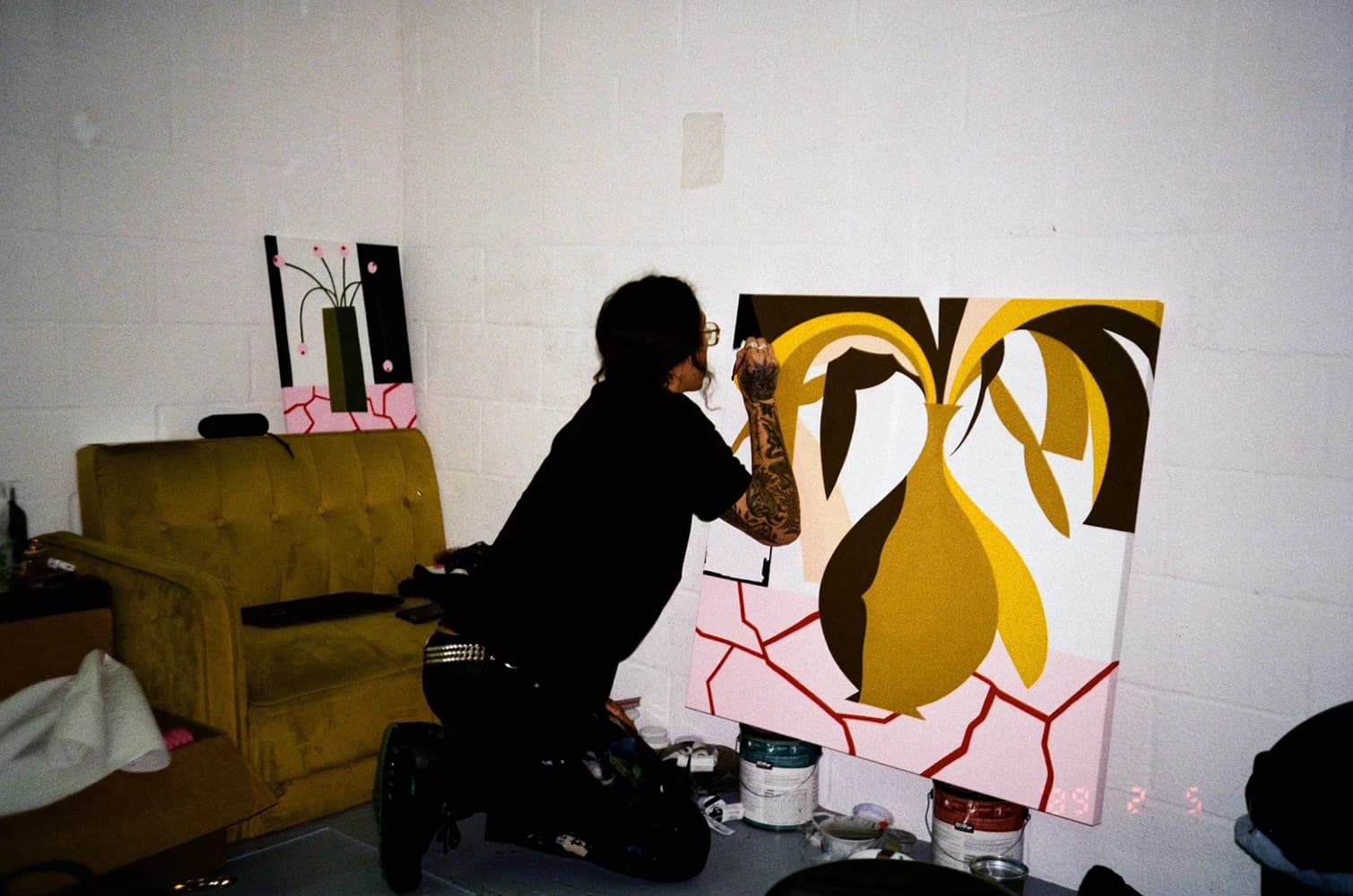 Artist Eddie Perrote working on an abstract floral still life painting in his studio.