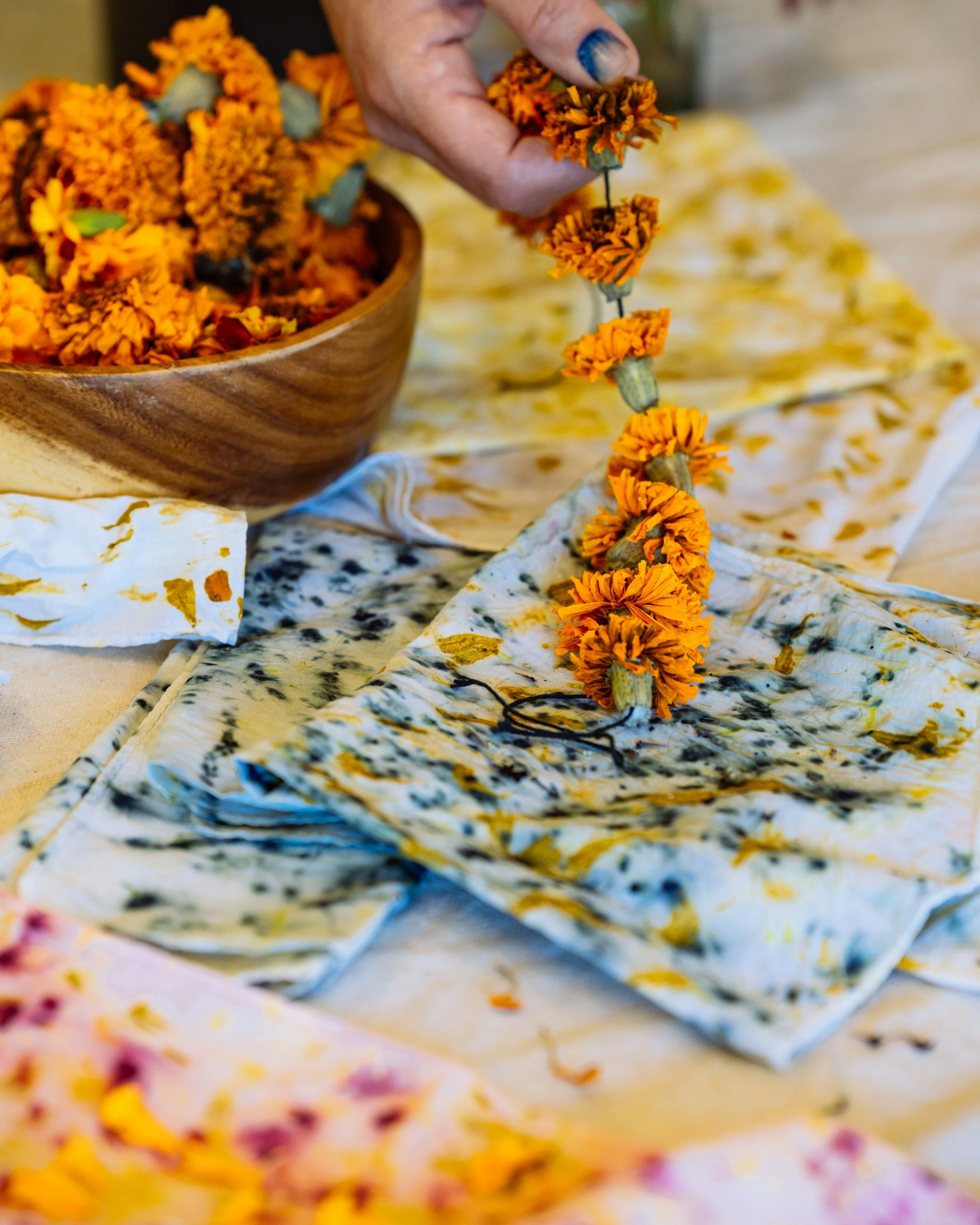 Artist Carrie Crawford creating natural dyes from orange flowers.