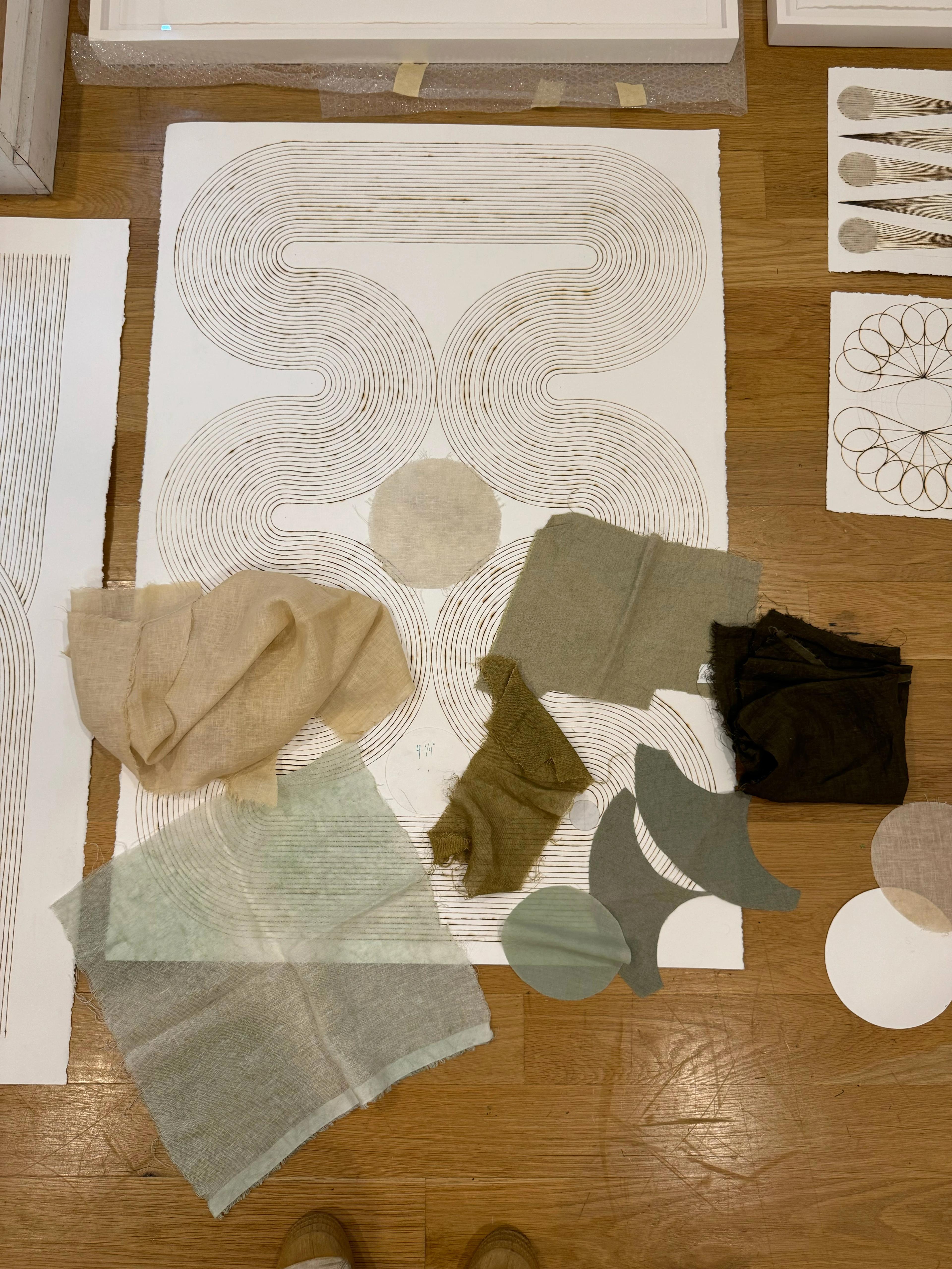 An in-progress geometric artwork with handburnt lines and textile pieces by artist Katrine Hildebrandt-Hussey.