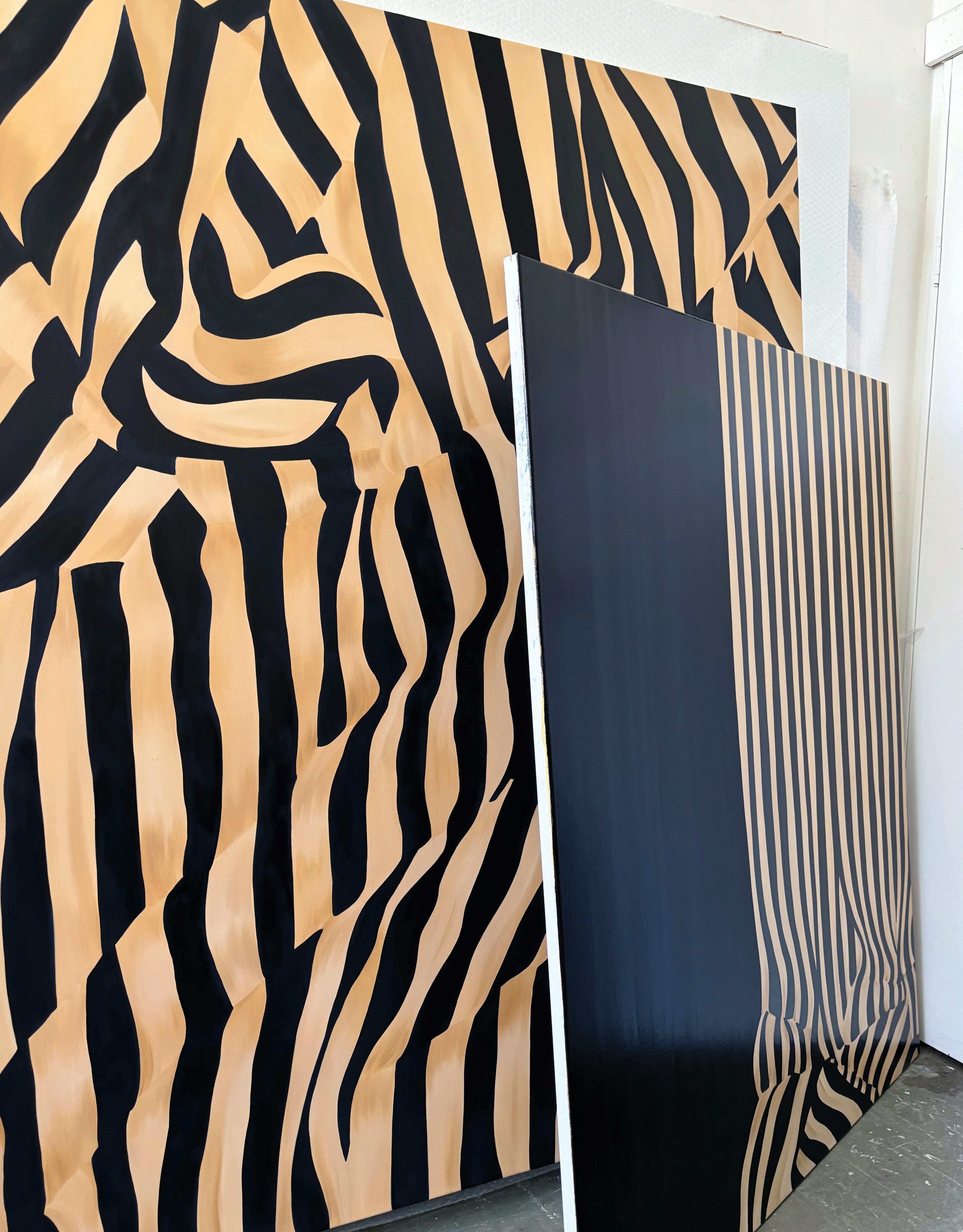 Striped, gold and black paintings of fabric by artist Caroline Walls in her Melbourne studio.