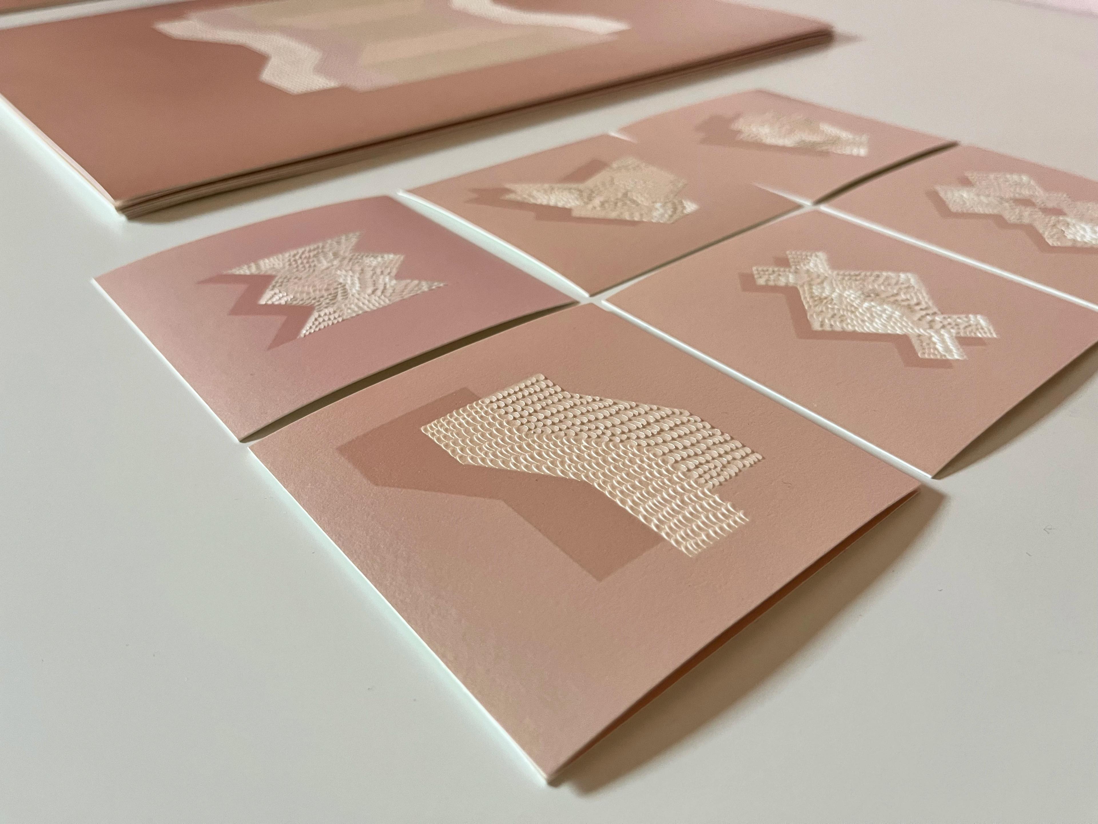 Pink knife-cut drawings by artist Lucha Rodríguez in her studio.