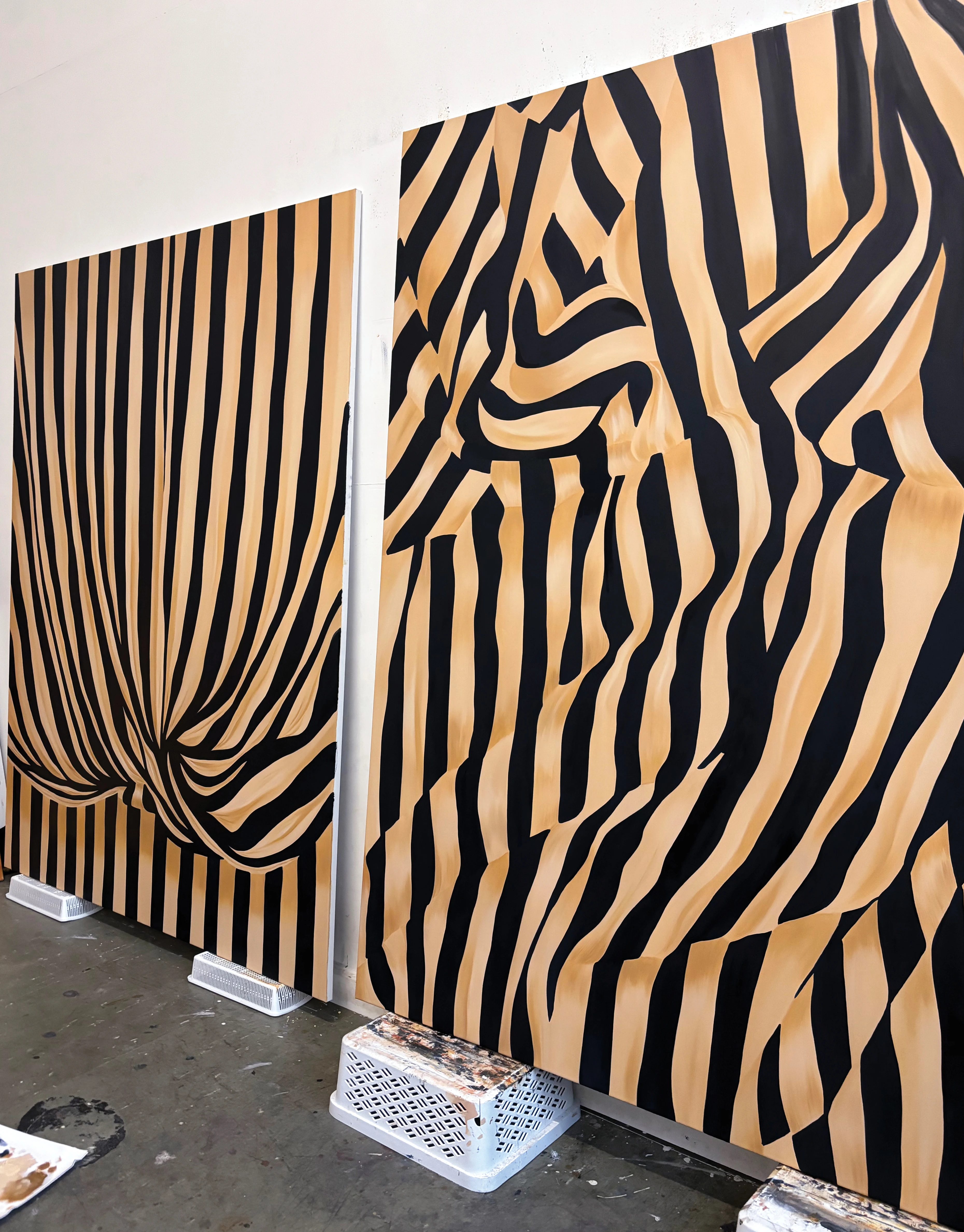 Large, striped beige and black works on canvas by artist Caroline Walls.