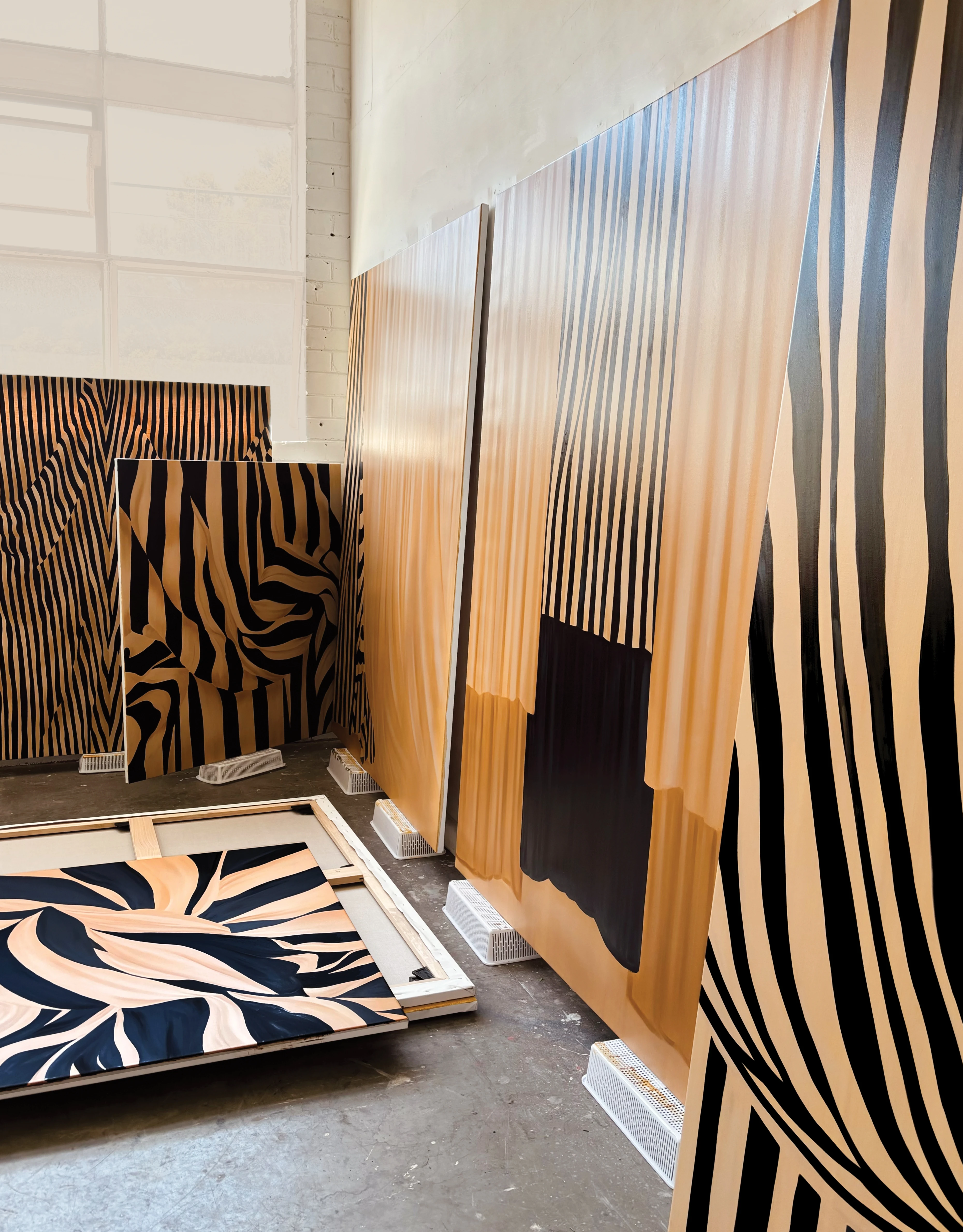 Large, striped works on canvas of fabric by artist Caroline Walls.