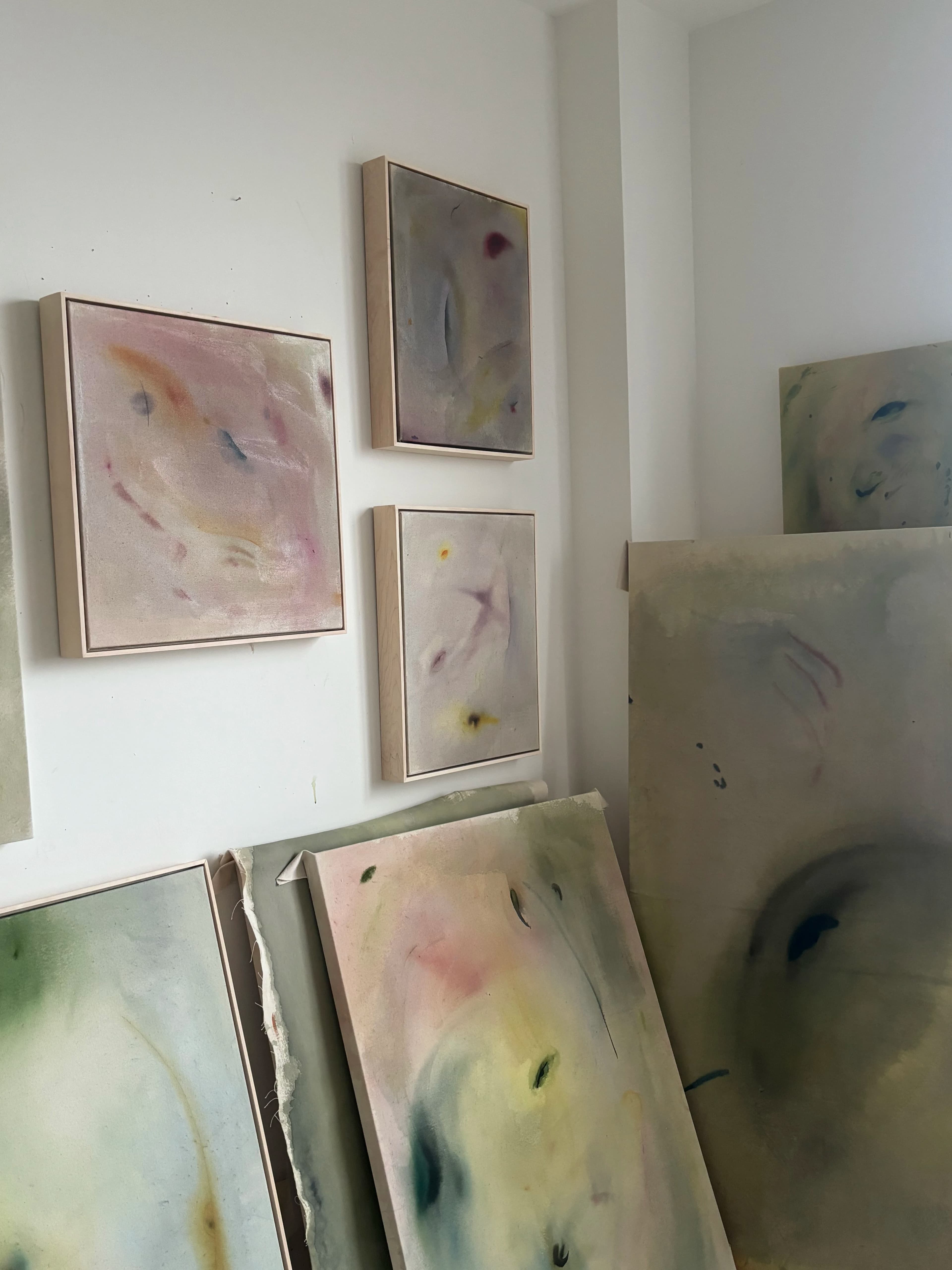 Gestural, abstract paintings on canvas by artist Arlina Cai in her studio.