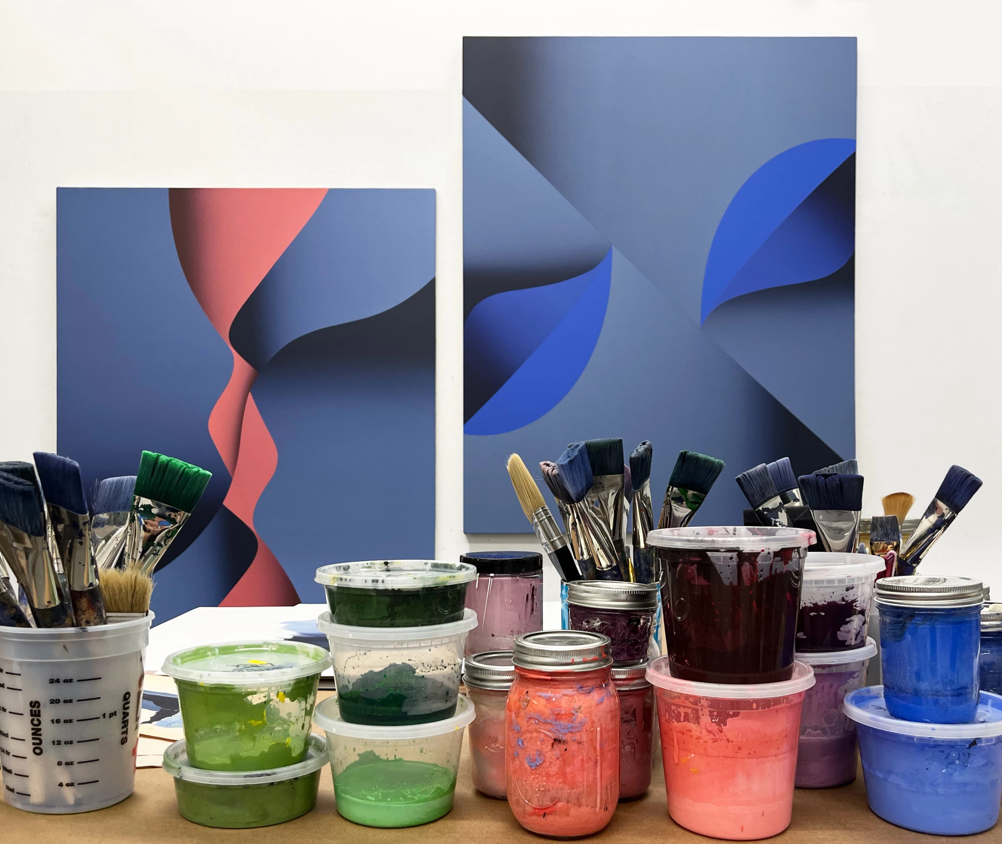 Two abstract red and blue paintings by artist Senem Oezdogan in her studio. 