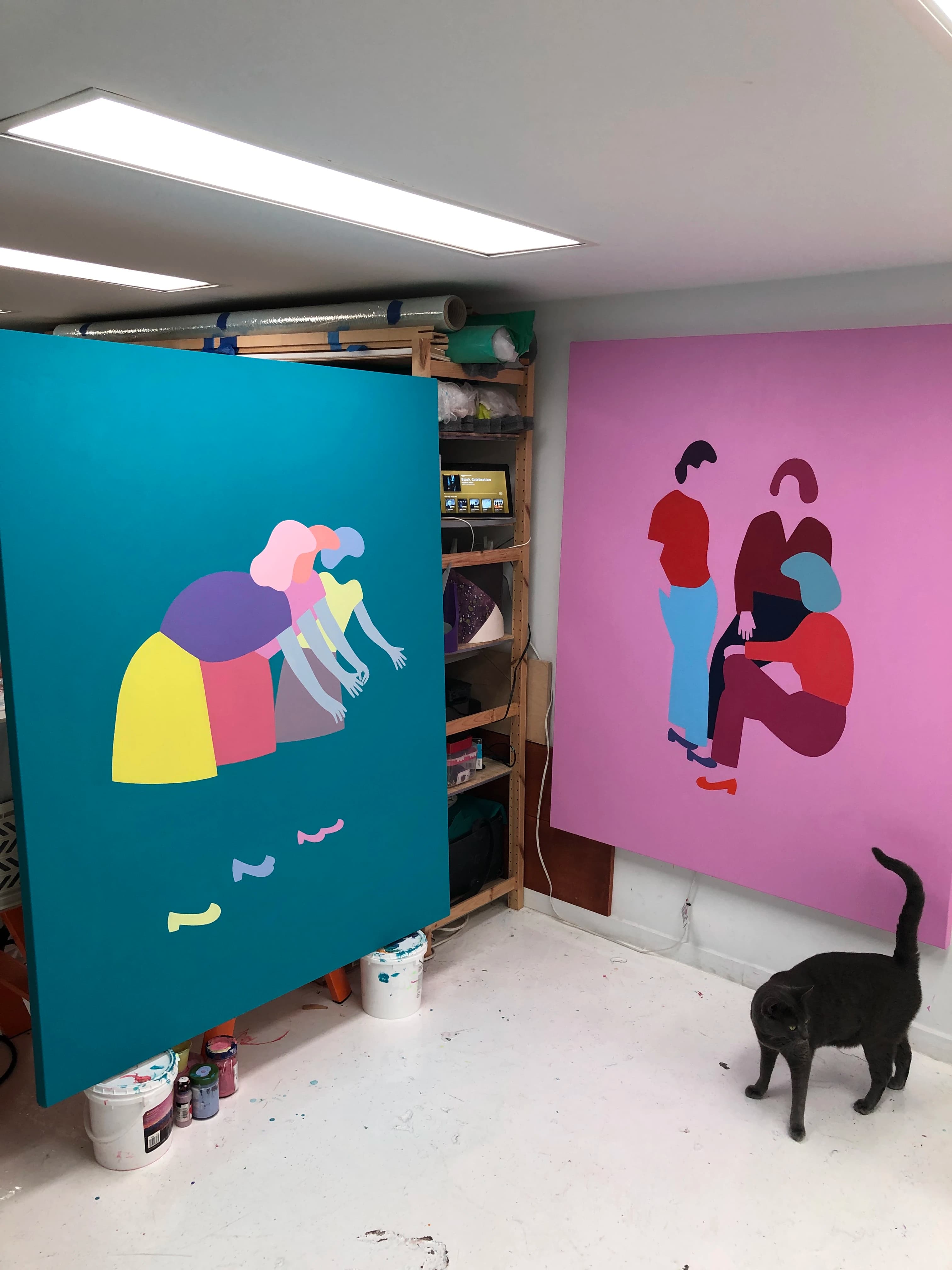 Two large colorful, figurative paintings on canvas in artist Dana Bell's studio.