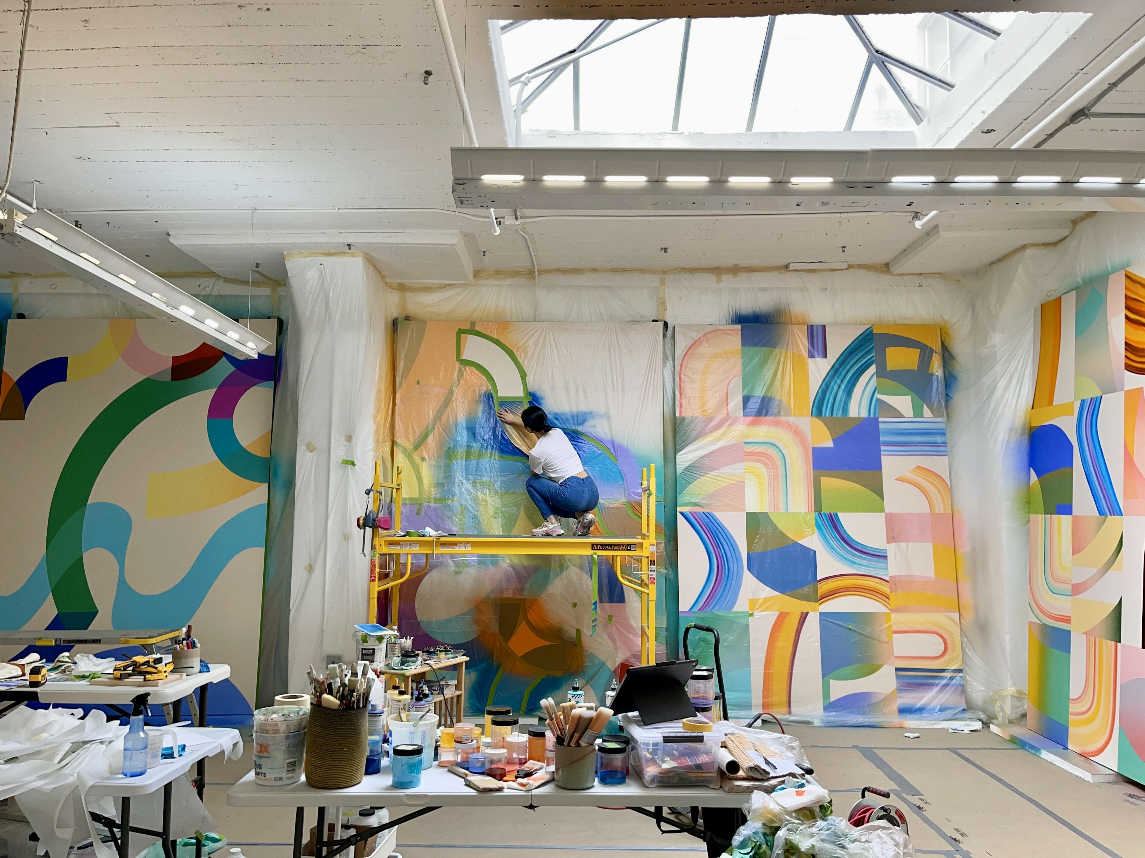 Erin Zhao painting in her studio.