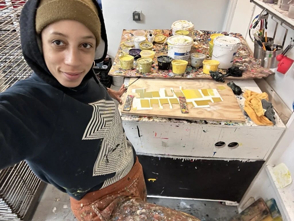 Leslie Diuguid working with swatches of yellow in her fine art screenprinting studio.