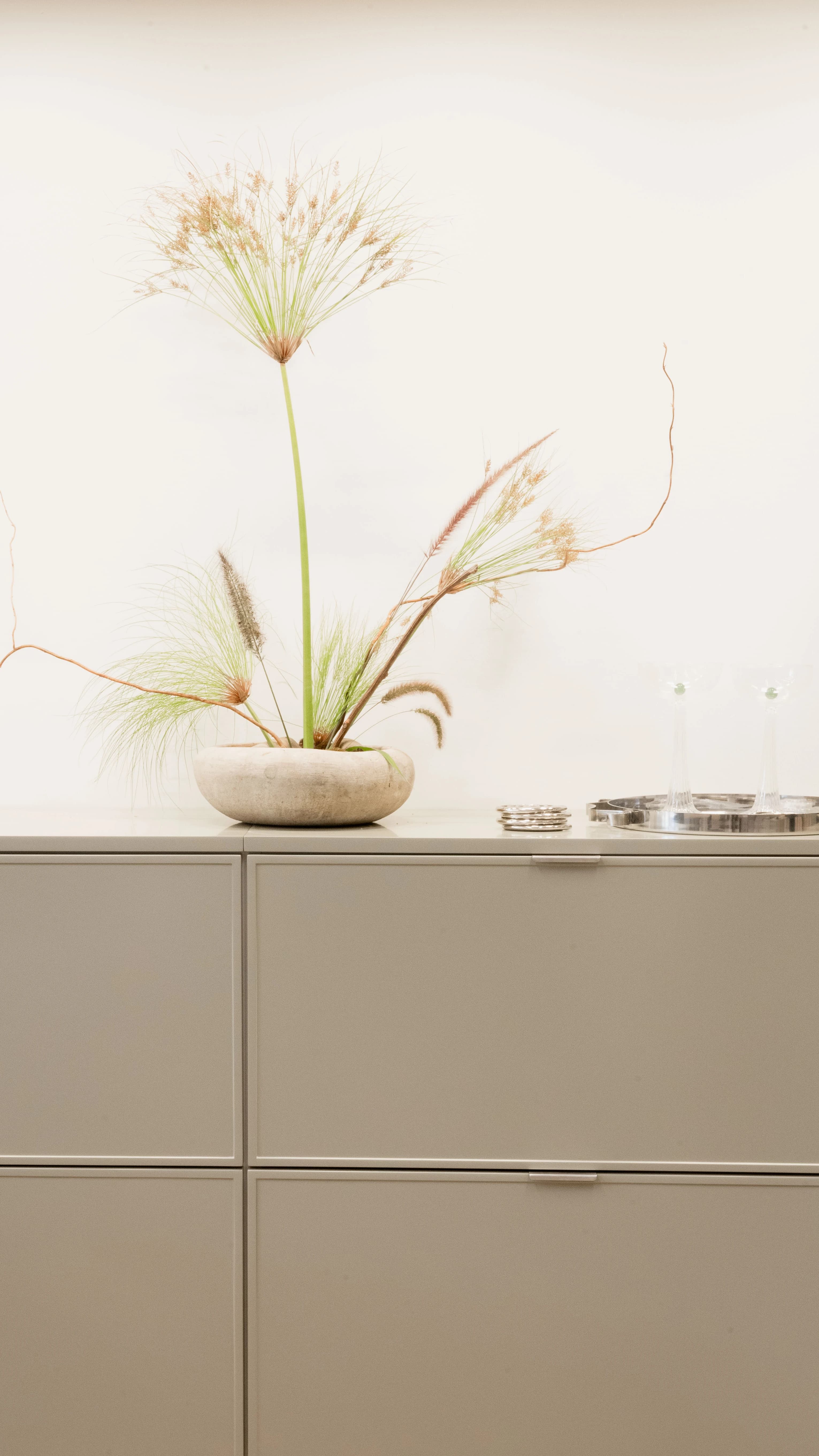 A floral arrangement on top of a sage green console table at Modern Citizen's New York store.